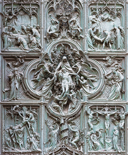 MILAN, ITALY - SEPTEMBER 16, 2024: The detail from main bronze gate of the Cathedral -   Deposition (Pieta) by Ludovico Pogliaghi (1906).
