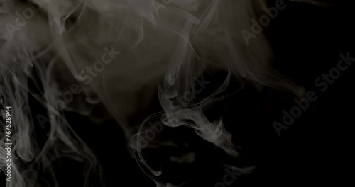 Fading White Smoke Trails In Dark Background photo