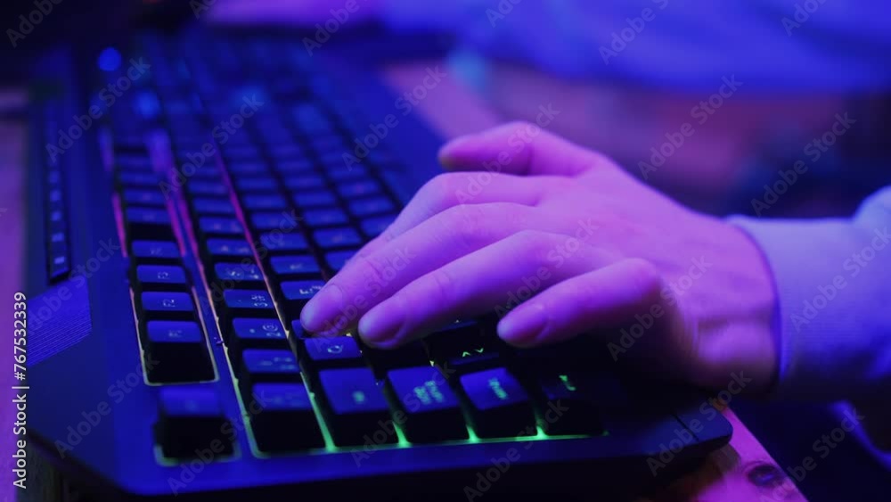 Gamer man typing on backlight keyboard close-up, man playing video game . Male hands pushing buttons on computer mouse. having a stream, cyberspace. Gamer man typing on backlight keyboard close-up, man playing video game . Male hands pushing buttons on computer mouse. having a stream, cyberspace.