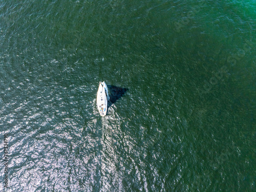 Drone view of a boat on Lake Michigan making a wake in the water 