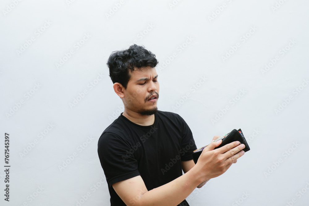 Poor man hold empty wallet and thinking about rich