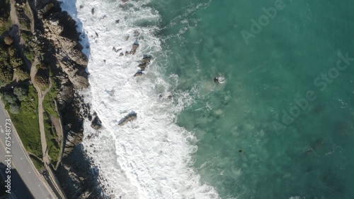 4K overhead of the Monterey Bay and Pacific Grove Rec Walk with an echelon of Pelicans flying directly underneath the camera. photo