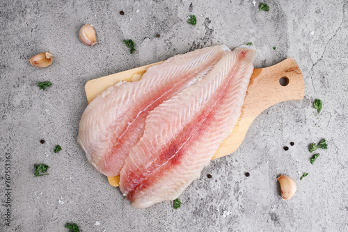 Top view of fresh fillet dory fish on wooden tray photo