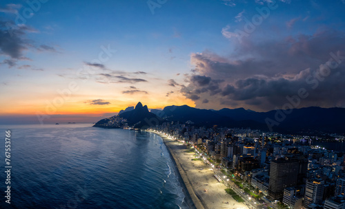 Sunset on Ipanema Beach with Dois Irmaos mountains in Rio de Janeiro, Brazil. Aerial view	