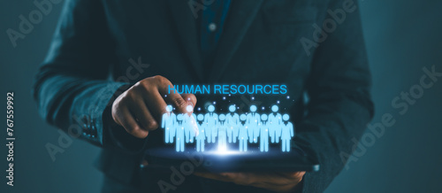 HR, Human Resources management concept. Recruitment, Employment, Headhunting, Team building. Businessman use tablet with HR icon on virtual screen. photo