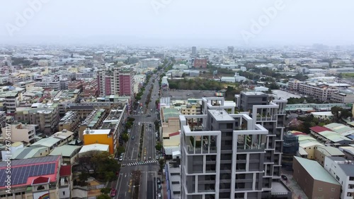 Overcast cityscape with buildings stretching to the horizon, elevated view, subdued colors, urban
