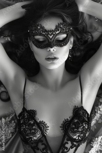 Enigmatic Black-Haired Beauty in Elegant Lace and Masquerade Mask, Lying on her Back, Magic and Fantasy in Black and White. 