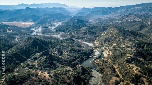An aerial view of a mountainside covered in barren land and rocky outcroppings contrasted with the same area after the atmospheric river now a lush forest with a winding river