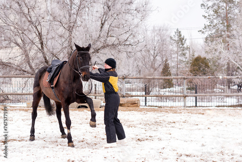 Person leading a lively horse in snow. Dressage.
