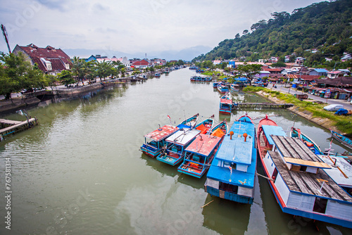View of the Batang Arau River seen from the top of the Siti Nurbaya Bridge in Padang City, West Sumatra, Indonesia. The Siti Nurbaya Bridge is a famous bridge in Padang and a tourist destination. photo
