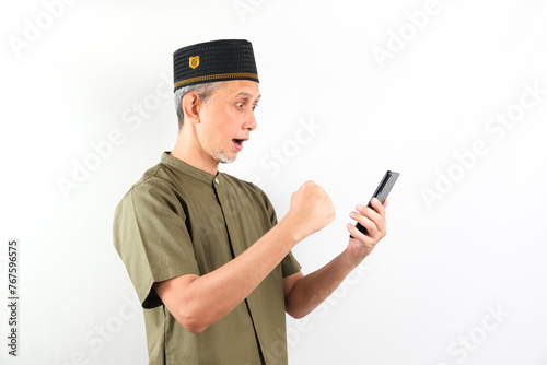 Portrait of Asian Moslem Man looks happy with holding the phone.
 photo