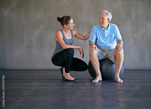 Exercise ball, talking and physiotherapist with patient for muscle exercise consultation at clinic. Physical therapy, consultation and healthcare worker helping senior man at rehabilitation center.