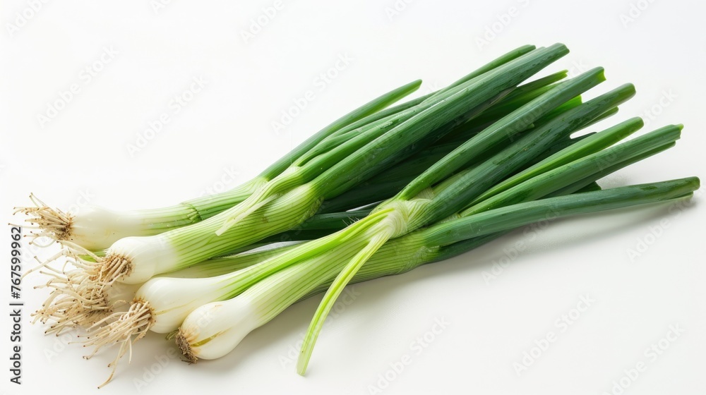 A bunch of green onions are displayed on a white background. The onions are fresh and ready to be used in cooking A bunch of green onions are displayed on a white background. The onions are fresh and ready to be used in cooking