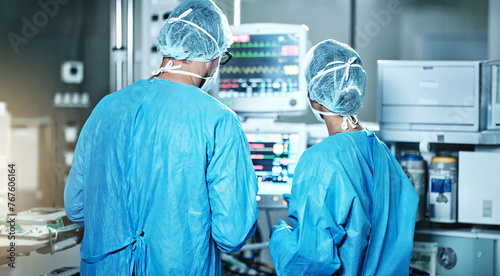 Surgery, back or surgeons with teamwork for emergency, accident or healthcare in hospital clinic. Heart rate monitor, medical or doctors in surgical collaboration in operating room to support or help