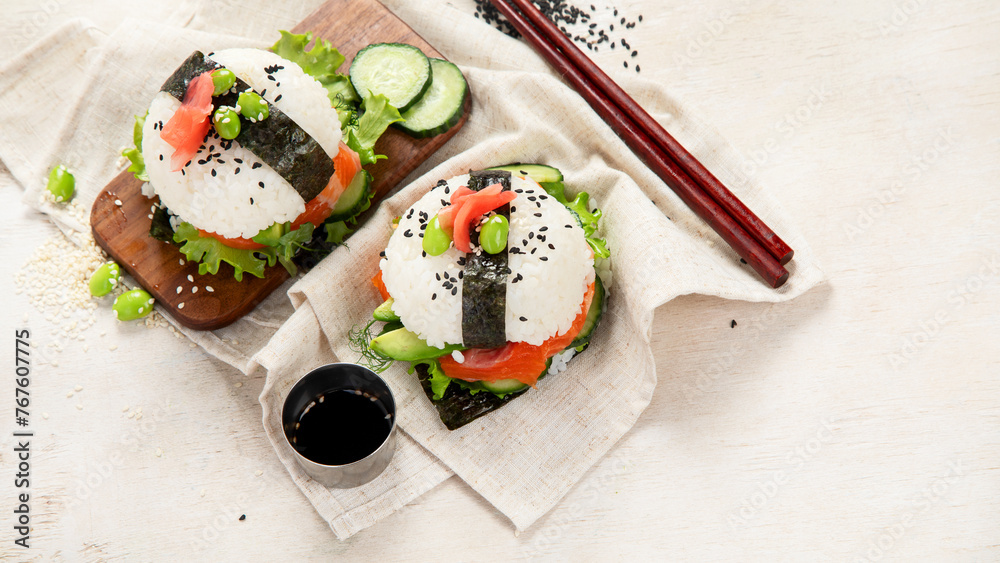 Hybrid modern food. Sushi burger with salmon, white rice, avocado, cucumber. - obrazy, fototapety, plakaty 