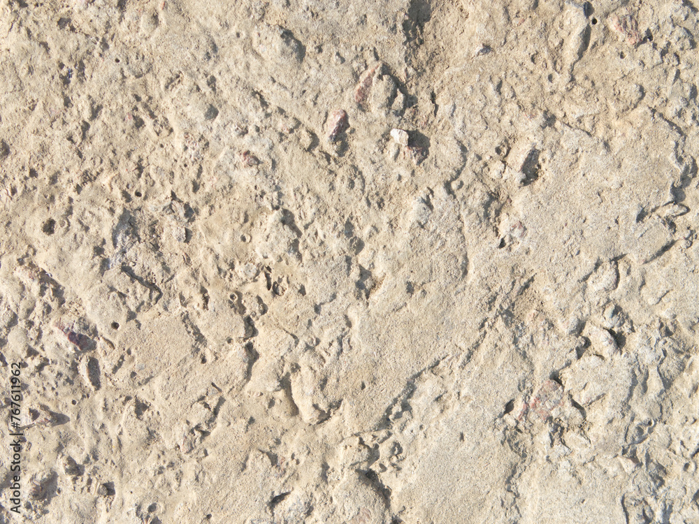 The texture of old concrete with stones frozen in it. Closeup The texture of old concrete with stones frozen in it. Closeup