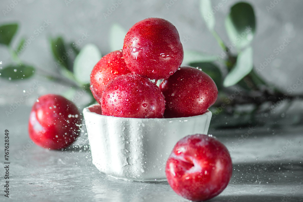 Free sweet red plums on dark background Free sweet red plums on dark background