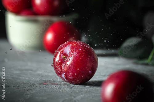 Free sweet red plums on dark background