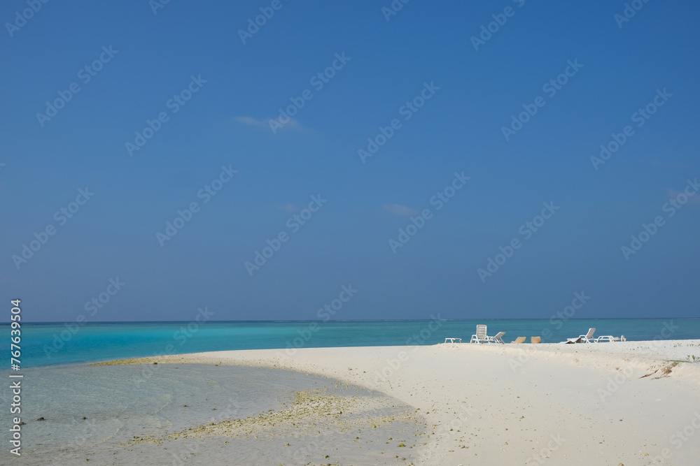 Mathiveri is one of the westernmost islands in the Maldives, beautiful beach scene with crystal clear blue water with resting beach bench. Mathiveri is one of the westernmost islands in the Maldives, beautiful beach scene with crystal clear blue water with resting beach bench.