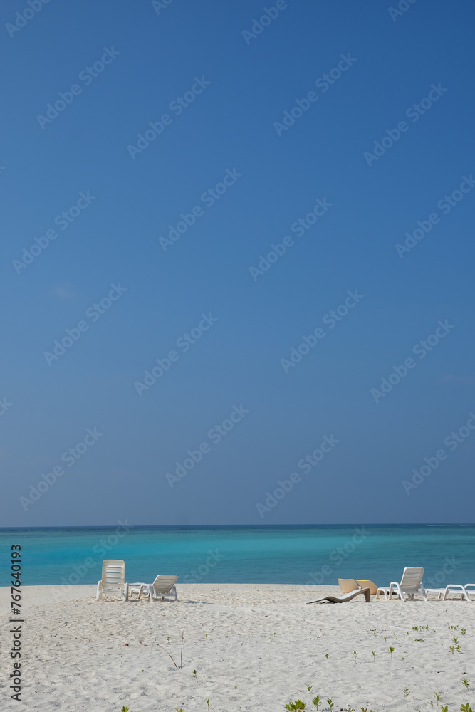 Mathiveri is one of the westernmost islands in the Maldives, beautiful beach scene with crystal clear blue water with resting beach bench. Mathiveri is one of the westernmost islands in the Maldives, beautiful beach scene with crystal clear blue water with resting beach bench.