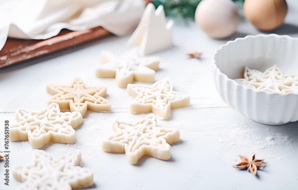 christmas cookie cutters and gingerbread dough cooking on white