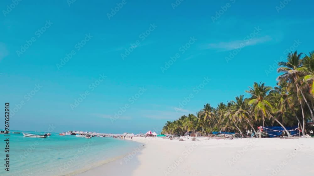 Tropical beach with coconut trees at Agatti island, Lakshadweep, India. Tropical coast with blue sky and calm sea. Beach on the tropical island. Travel and holidays background.
Tropical beach with coconut trees at Agatti island, Lakshadweep, India. Tropical coast with blue sky and calm sea. Beach on the tropical island. Travel and holidays background.