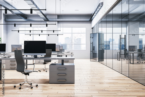 A modern office interior with desks, chairs, and computers, lots of natural light from large windows, and a cityscape view. 3D Rendering photo