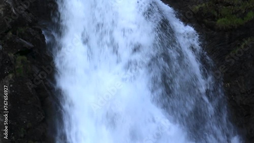 Close-up with vertical panoramic camera movement from top to bottom of the waterfall. Saut deth Pish in the Aran Valley (Catalan Pyrenees) photo