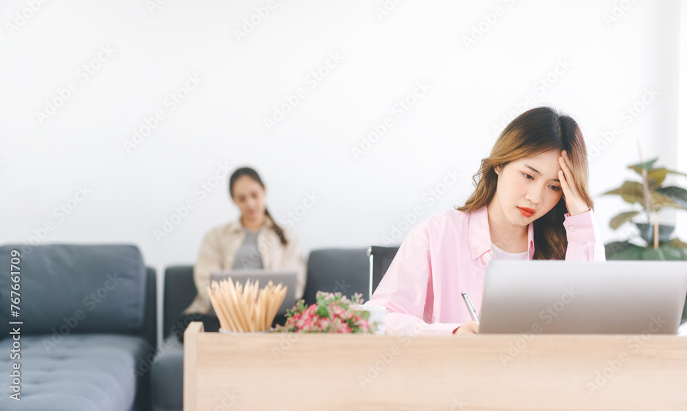 Woman fatique and stress using laptop computer at home office