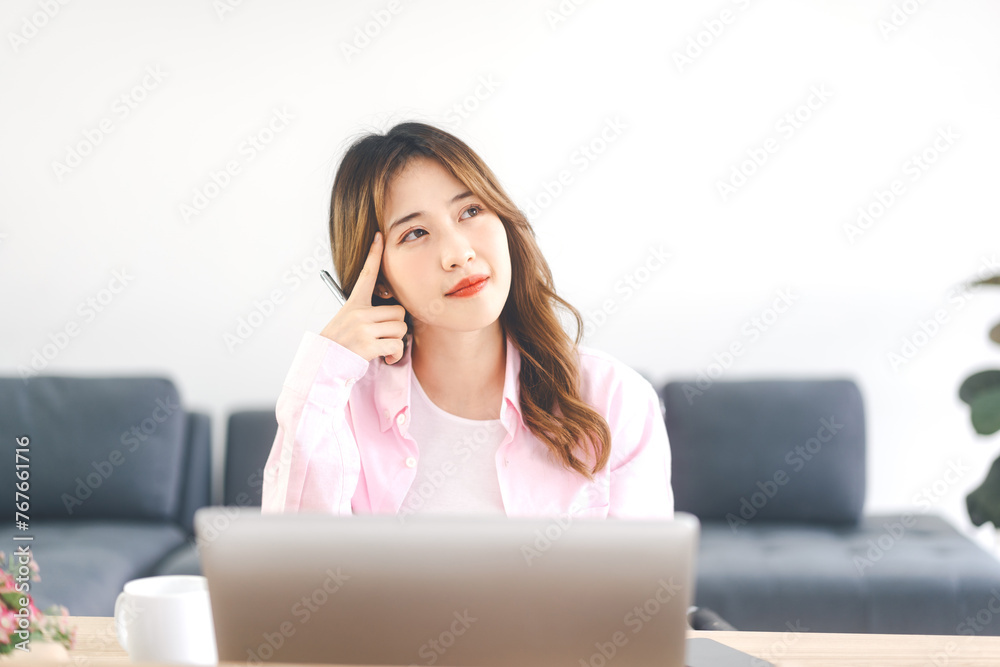 Portrait of young adult southeast business asian woman thinking new idea at work place Portrait of young adult southeast business asian woman thinking new idea at work place