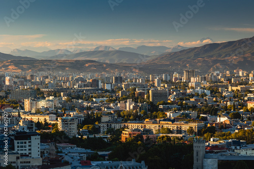 View of Tbilisi from the surrounding hills. In the background you can see the Caucasus Mountains. A warm autumn day in the capital of Georgia.
