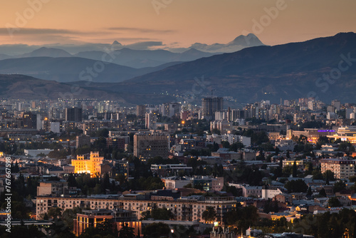 View of Tbilisi from the surrounding hills. In the background you can see the Caucasus Mountains. A warm autumn day in the capital of Georgia. © PawelUchorczak
