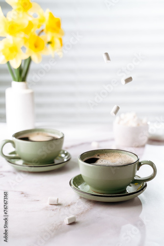 coffee cups with strong coffee on the table, spring atmosphere, space for text