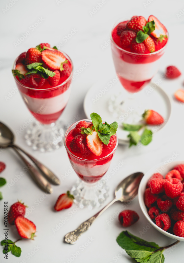 Layered berry, jelly and mousse parfait desserts on white background. Layered berry, jelly and mousse parfait desserts on white background.