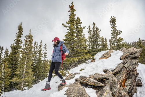 Woman hiking down a mountain in Colorado