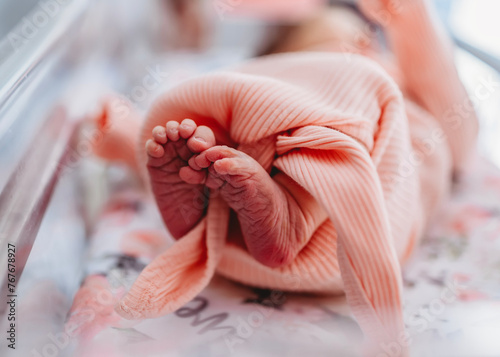 Close up of newborn baby girl's tiny feet and toes