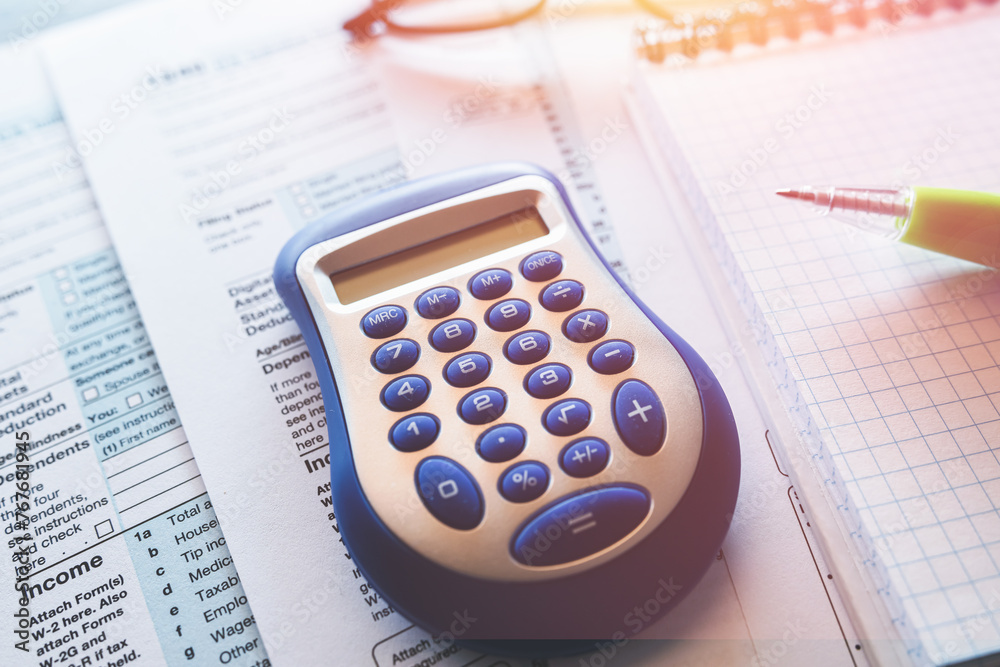 1040 TAX form blank on a calculator. Individual Income Tax Return 1040 TAX form blank on a calculator. Individual Income Tax Return