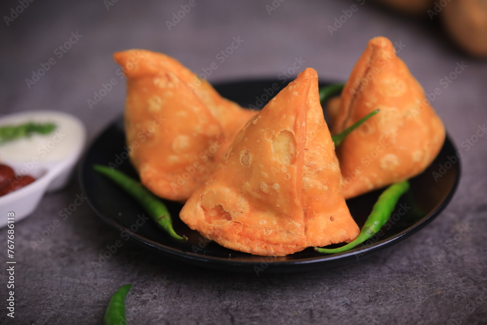 Samosa Indian famous street food snack closeup with selective focus and blur
