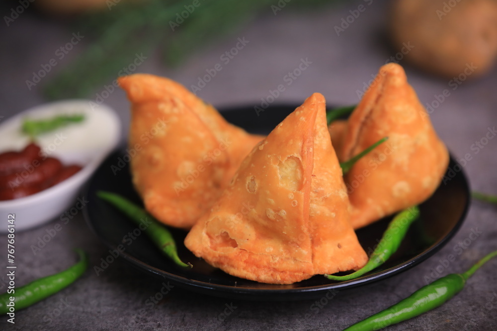 Samosa Indian famous street food snack closeup with selective focus and blur Samosa Indian famous street food snack closeup with selective focus and blur