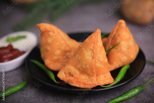 Samosa Indian famous street food snack closeup with selective focus and blur