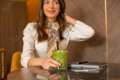 Glass of a green smoothie in the restaurant