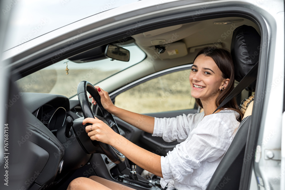 portrait of young woman driver at inside car