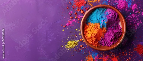 A bowl of colorful powder is on a purple background. The bowl is filled with a variety of colors, including red, yellow, and blue. Concept of creativity and playfulness, as the colors are bright © Dawid