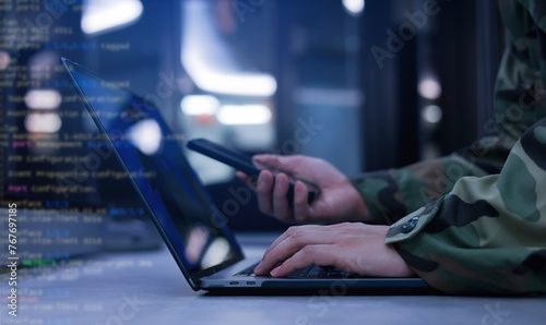 close up soldier man as programmer hand typing command on keyboard laptop to check about software or configuration for military operation system in office room concept