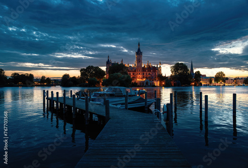 Schloss Schwerin im Abendlicht mit Steg und Booten photo