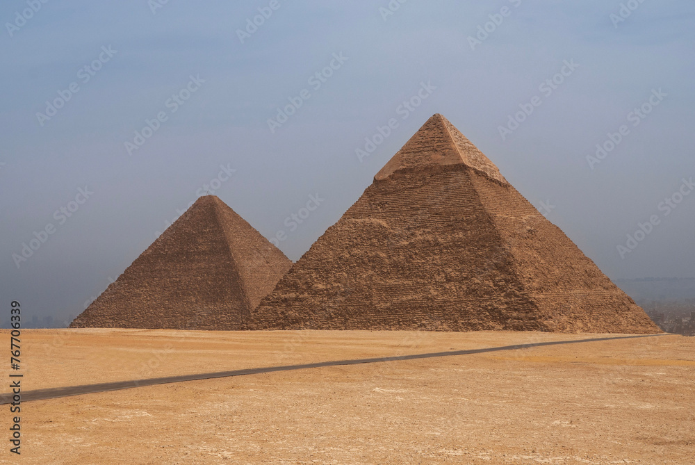Pyramids of Khafre (Khafre) and Mikerin (Menkaura) against background of blue spring sky. Close-up. Giza Pyramid Complex is complex of ancient monuments on Giza Plateau. Cairo, Egypt - April 18, 2008 Pyramids of Khafre (Khafre) and Mikerin (Menkaura) against background of blue spring sky. Close-up. Giza Pyramid Complex is complex of ancient monuments on Giza Plateau. Cairo, Egypt - April 18, 2008