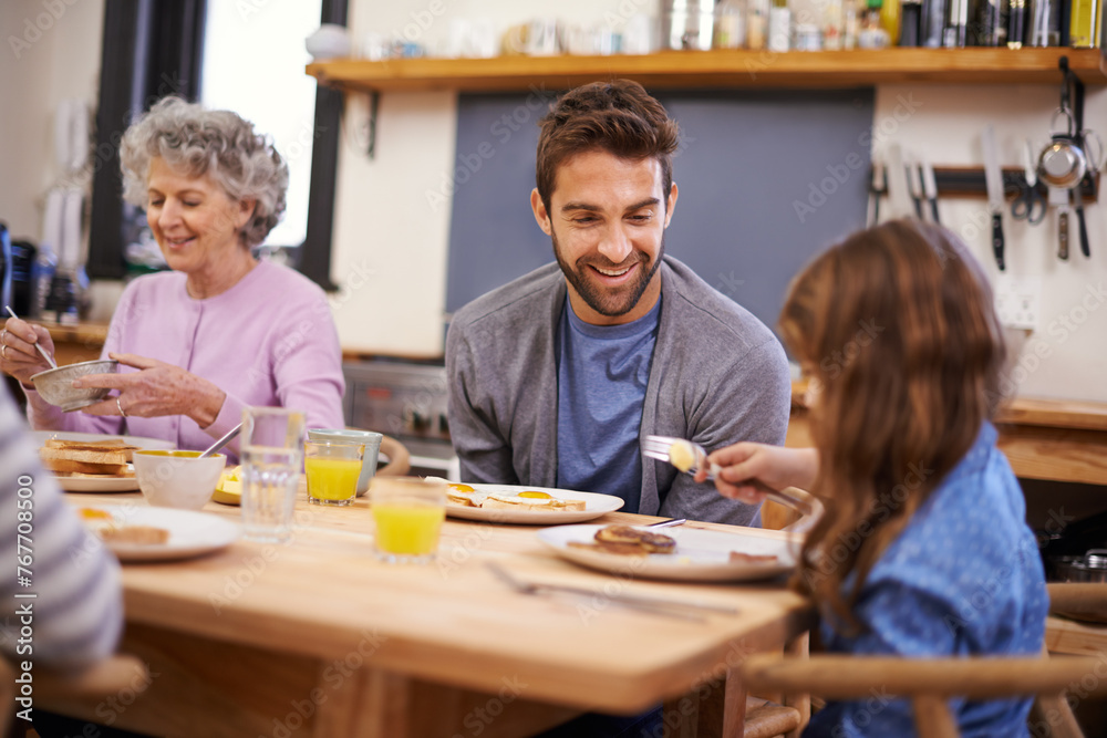 Love, breakfast and family in a kitchen with pancakes, eating or bonding at a table together. Food, diet and girl with father, grandmother and waffle for brunch, nutrition or communication at home Love, breakfast and family in a kitchen with pancakes, eating or bonding at a table together. Food, diet and girl with father, grandmother and waffle for brunch, nutrition or communication at home