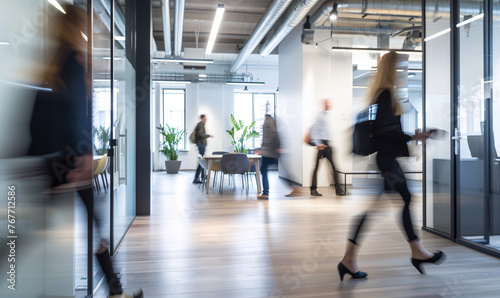 modern glass office with motion blur people walking through with wooden floor