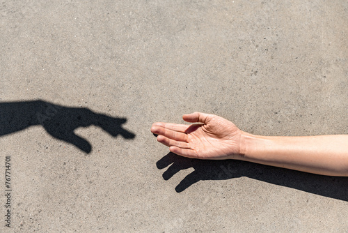 gesture, help and people concept - close up of human hand reaching to shadow © Syda Productions