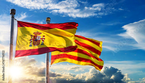 Close-up of a Spanish and Catalan flag (la Rojigualda and Senyera) with flagpole, blowing in the wind on a blue sky with clouds, sunbeams and copy space. Generative Ai. photo
